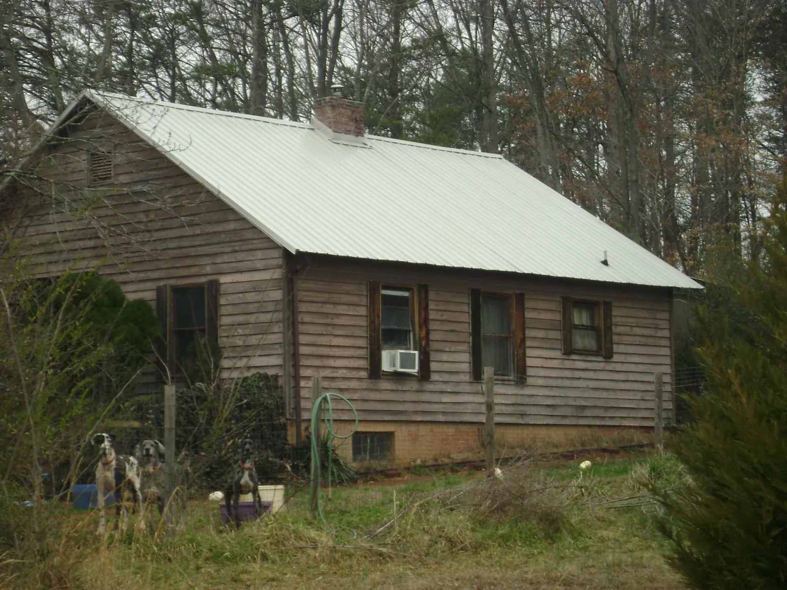 White metal roof on an old wood sided farmhouse, from a Metal Roof Installation job in Mc Causland